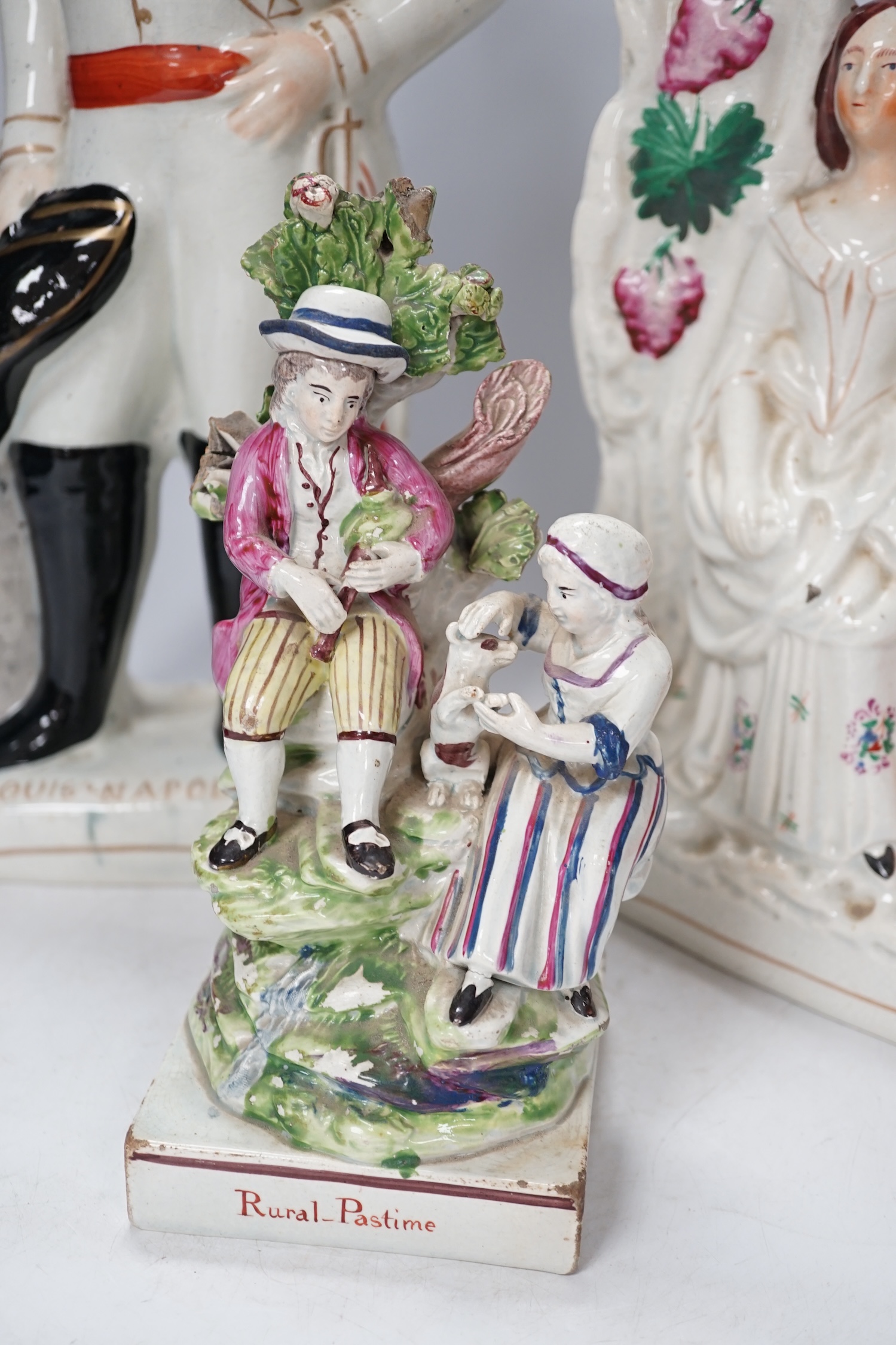 A group of three Staffordshire figures, to include a figure of Louis Napoleon, 'Rural Pastime', the cobbler and wife, tallest 41.5cm. Condition - fair